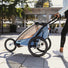 kit jogging pour remorque single thule vue de la poussette bleue avec joggeuse