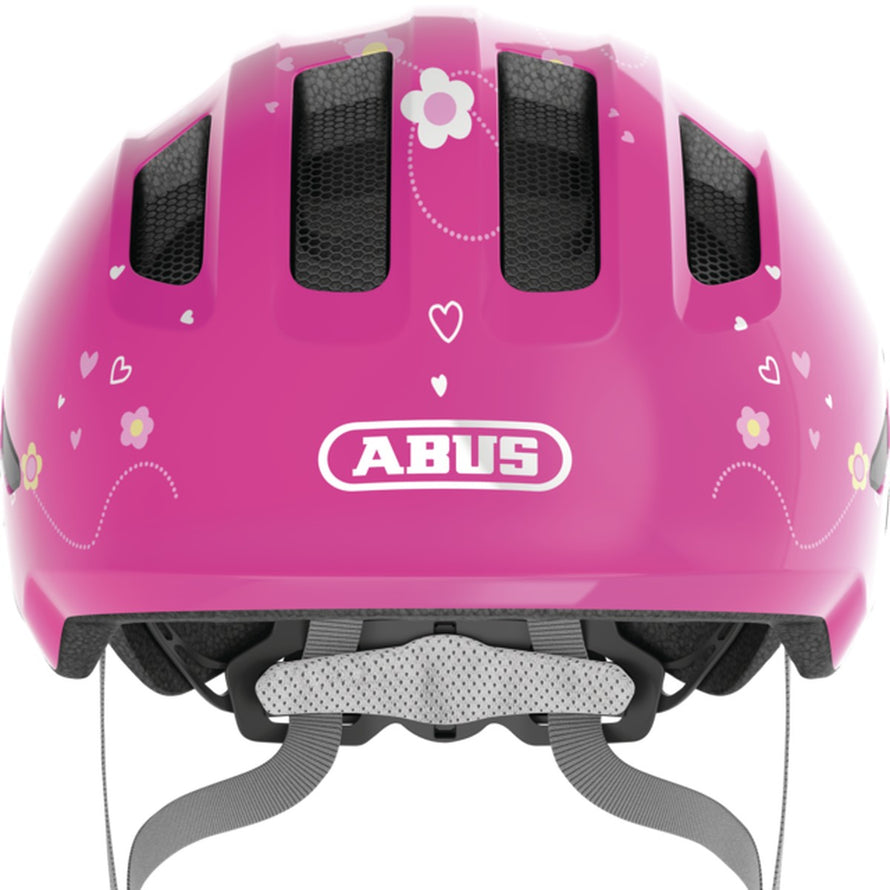 Casque vélo bébé Abus Smiley 3.0 rose avec motifs fleurs et coeurs, sécurité et confort pour enfant