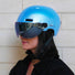 Casque vélo connecté Cosmo Connected Fusion bleu porté par une femme en milieu urbain avec visière intégrée