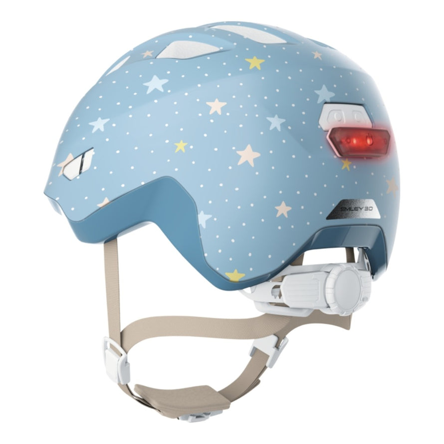 Casque vélo enfant Abus Smiley 3.0 FL.ACE LED bleu clair étoiles avec fermeture magnétique et lumière LED arrière