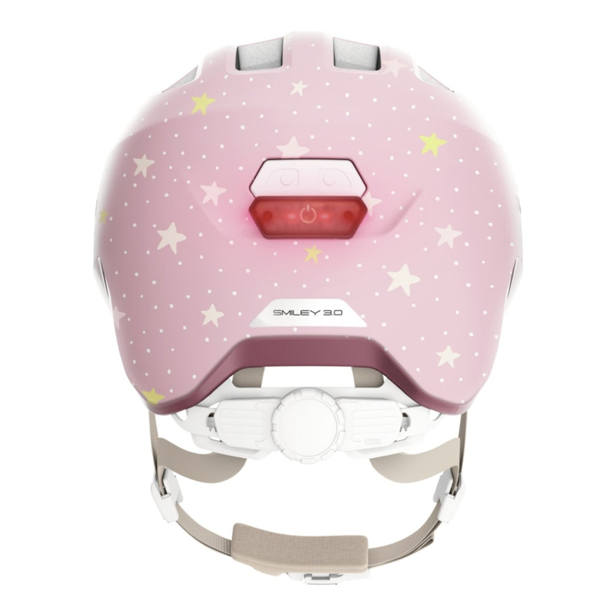 Casque vélo enfant Abus Smiley 3.0 FL.ACE LED rose étoiles avec éclairage arrière et fermeture magnétique sécurisée