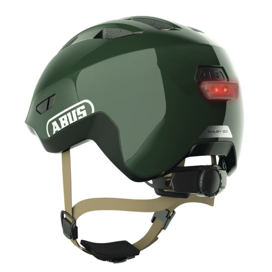 Casque vélo enfant Abus Smiley 3.0 FL.ACE LED vert foncé avec éclairage arrière et fermeture magnétique sécurisée