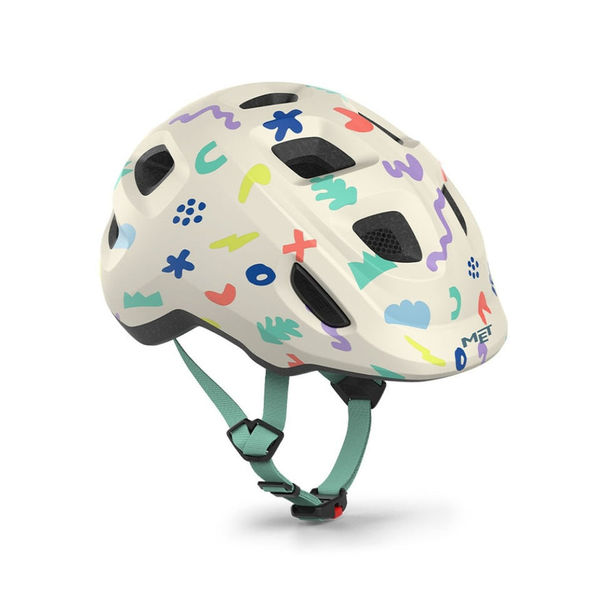 Casque velo enfant Hourra MET motifs geometriques pastel avec sangle verte, compatible siege velo enfant pour securite et confort