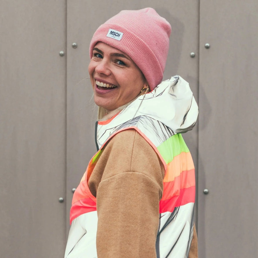 Femme souriante portant le gilet reflechissant multicolore Darkflow de la marque GoFluo pour securite velo