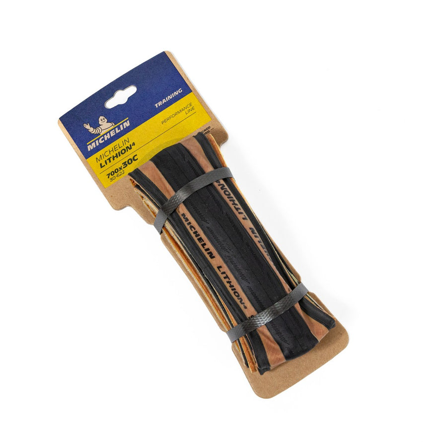 Pneu Michelin Lithion 4 700x30c avec bande brune, alliant endurance et adhérence pour cyclistes sur route
