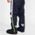 Pantalon de pluie Urban Circus Iyuc bleu marine avec bandes réfléchissantes latérales pour cyclistes urbains.