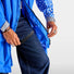 Poncho vélo zippé réfléchissant Urban Circus Francigena bleu intense, protection pluie et haute visibilité pour cyclistes urbains