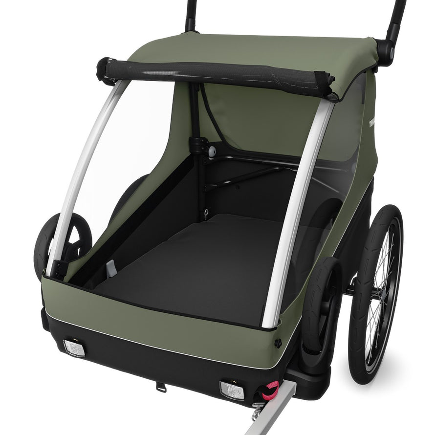 Remorque enfant Thule Courier 2 places en vert avec fonction poussette et cargo pour balades à vélo confortables
