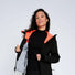 Veste de vélo réfléchissante Urban Circus Repop noire avec intérieur orange pour cyclistes urbains exigeants