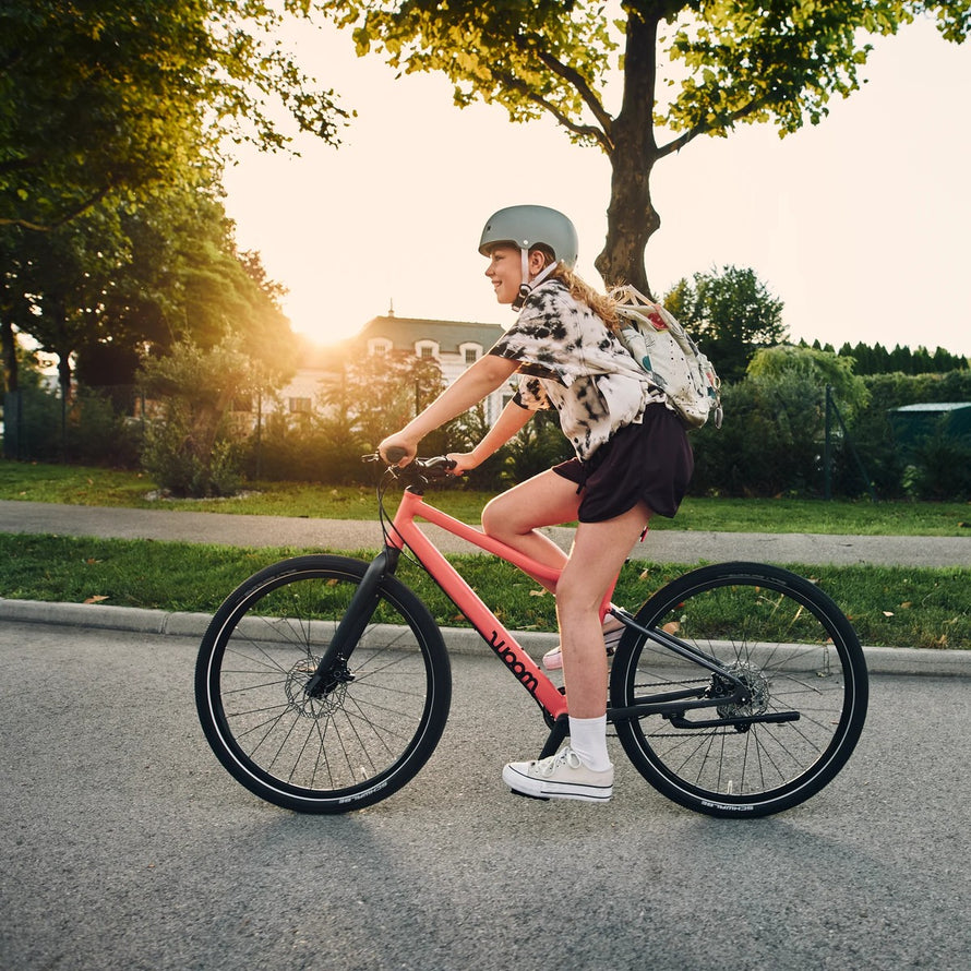 Enfant de 6 a 8 ans sur velo woom explore 4 20 pouces rouge en balade en plein air